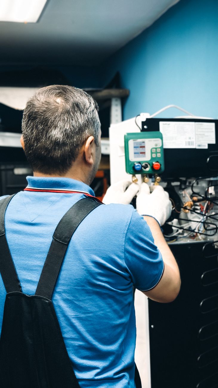 Technicien contrôlant les pressions d'un circuit frigorifique au manifold avant la mise en service